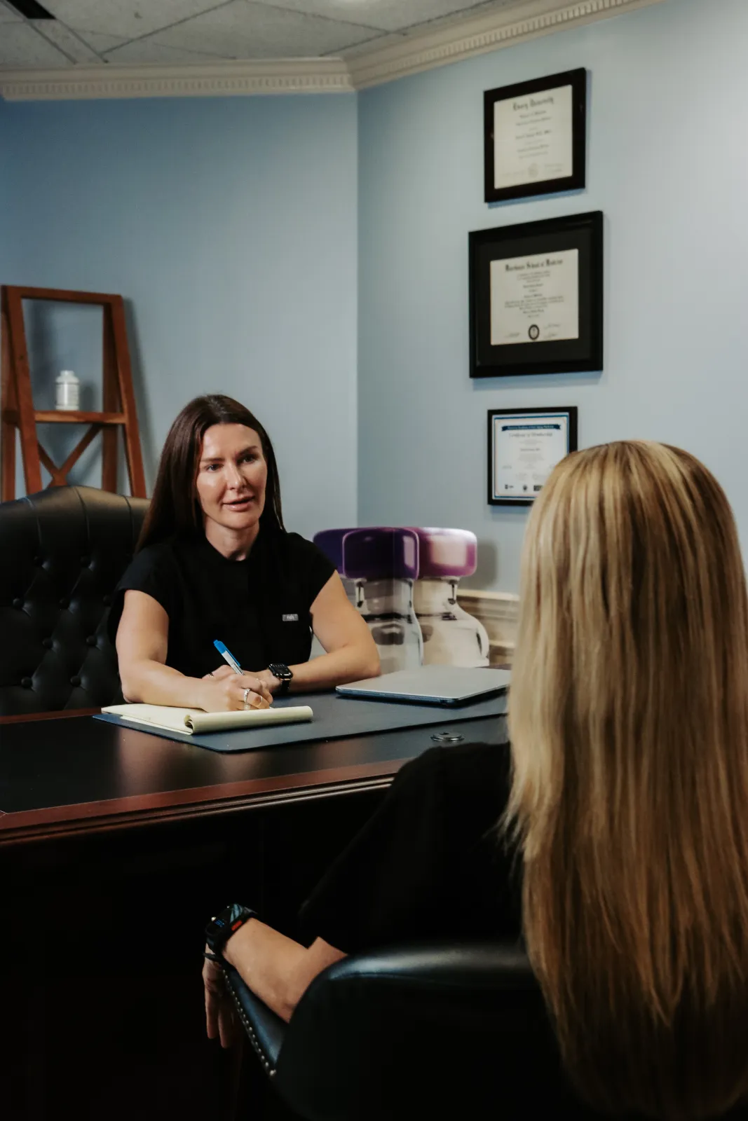 Rachael Feldman, NP-C, reviewing a personalized care plan with a patient at Elevate Wellness Clinic